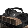 Black Over Ear Headphones Placed On Wooden Crate With Dark Cloth
