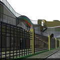 Colorful School Building With Green Roof And Playground Area Surrounded By Trees