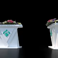 Modern White Reception Desks With Green Diamond Logo And Flower Arrangements