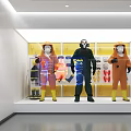 Protective Suit Mannequins Display In Glass Case With Yellow Wall Background