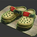Beige Rubber Clogs With Red Straps Blue Buckles And Perforated Design On Wooden Platform