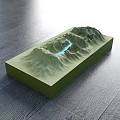 Green Mountain Terrain Commercial Equipment With Blue Water Flow Lines On Dark Wooden Floor