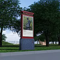 Outdoor Billboard Featuring Sculpture Painting In Park With Green Trees And Grass