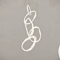 Modern White Chandelier with Curved Lines Design Hanging Against Gray Wall
