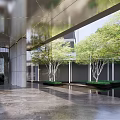 Modern Entrance Gate With Stone Columns Glass Canopy And High Rise Building Facade