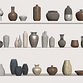 Various Ceramic Vessels in Different Colors and Shapes on White Shelves