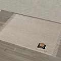 Square Woven Beige Rug With Tassel Edges And Small Tray Of Nuts On Wooden Floor