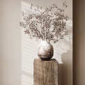 Dried Flowers Arranged in Ceramic Vase on Wooden Table Against Light Colored Wall