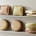 Pastel Colored Fringed Decorative Pillows In Square And Round Shapes On White Shelves