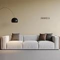 Three Seater Sofa With Beige Wall Floor Lamp Table Lamp On Side Table And Cushions