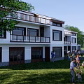 White Exterior Rural Self Built House with Balconies Lawn and Pond in Courtyard