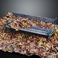 Rustic Wooden Bench Surrounded by Colorful Fallen Leaves with Metal Armrests