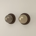 Round Wall Decor with Metallic Sphere and Brown Frame on Light Colored Wall 3d model