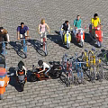 People With Various Colored Motorcycles And Bicycles On Cobblestone Outdoor Ground