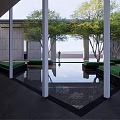 Modern Entrance Gate With Stone Columns Glass Canopy And High Rise Building Facade