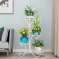 Tiered Metal Plant Stand With Colorful Flower Pots And Various Green Plants
