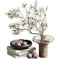 White Flower Branches In Transparent Vase On Textured Base With Black Bowl Purple Fruits