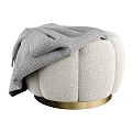 Plush Ivory Bouclé Fabric Ottoman With Gold Metal Base and Soft Gray Throw Blanket