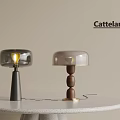 Cattelan Modern Designer Table Lamps With Transparent Shade And Wooden Base On White Round Table
