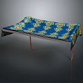 Elegant Table Featuring Blue Tablecloth With Yellow Green Patterns And Metal Legs