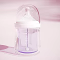 Transparent Baby Bottle With White Nipple Measurement Scale And Pink Background