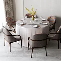 Modern Round Dining Table with Upholstered Gray Chairs Wooden Legs and Vase Flowers