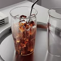 Refreshing Cold Brown Beverage with Ice Cubes in Glass and Empty Glass on Metal Tray