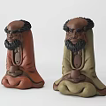 Artistic Sculpture Carving Featuring Bearded Human Figures In Brown Green Color And Sitting Pose