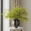Stylish Black Textured Vase With Lush Green Foliage On White Pedestal Table