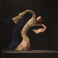 Abstract Sculpture With Curved Design On Display Stand In Dark Setting