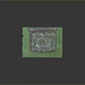 Decorative Stone Pedestal With Moss Covered Top And Carved Details On Green Grass