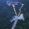 Aerial View of Ancient Architecture Complex with Lush Trees and Illuminated Roads