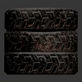 Three Stacked Tires With Dark Rusty Tread Pattern Against Gray Background