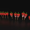 Fresh Strawberries on Wooden Sticks with White Stripes Against Black Background