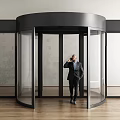 Modern Revolving Door With Glass Panels And Man In Suit Talking On Phone
