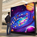 Commercial Digital Display Screen With Space Planets Design In Mall Setting For Viewing