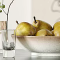 Fresh Ripe Pears In Ceramic Bowl With Green Plant And Glass Cups On Table