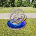 Art Installation With Transparent Sphere Ring Film Camera And Blue Illuminated Base On Green Grass