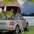 Stunning Mountain Lake Scenery With Silver SUV Roof Tent On Grassland