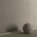 Decorative Sphere Component On Smooth Surface Against Gray Textured Wall
