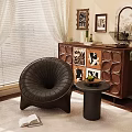 Dark Brown Leather Single Sofa With Curved Design Small Round Side Table And Green Plant