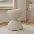 Modern White Round Stool On Wooden Floor With Curtain Window Blinds And Side Table Vase