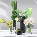 Elegant Glass And Black Vases With Tropical Leaves Calla Lilies And Pink Flowers