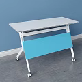 White Tabletop Desk With Blue Panel Sturdy White Frame And Wheels On Gray Floor
