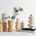 Decorative Vases With Greenery Various Shapes Neutral Tones Arranged With Stack Of Books