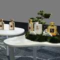Modern Tea Break Area Featuring Curved White Tables Green Plants And Snacks