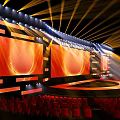 Spectacular Stage Design With Golden Lights Red Seats And Screens