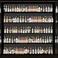 Modern Wine Cabinet with Multiple Shelves Displaying Various Wine and Liquor Bottles