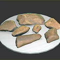 Brown Wooden Stone Pieces of Various Shapes Displayed on White Plate