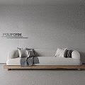Poliform Three Seater Sofa With Light Colored Upholstery Accent Pillows Throw Blanket And Wooden Base